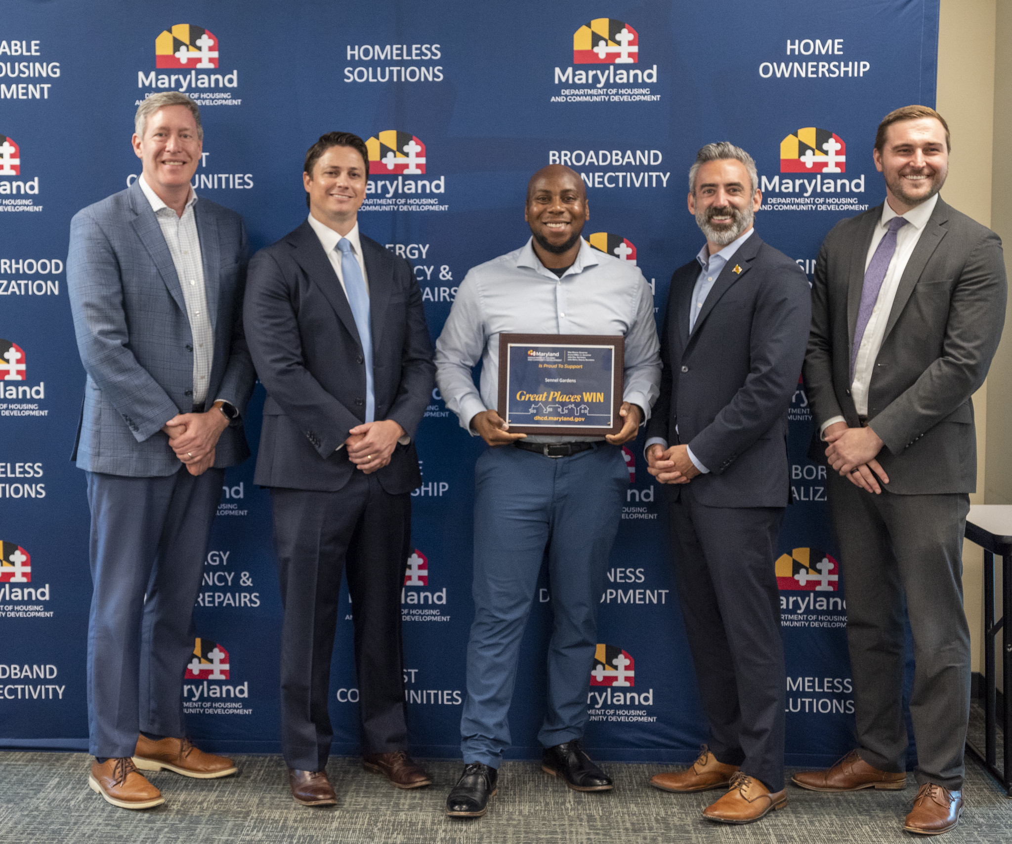 Manny McDaniel receiving the NourishMD grant plaque with Maryland officials at DHCD