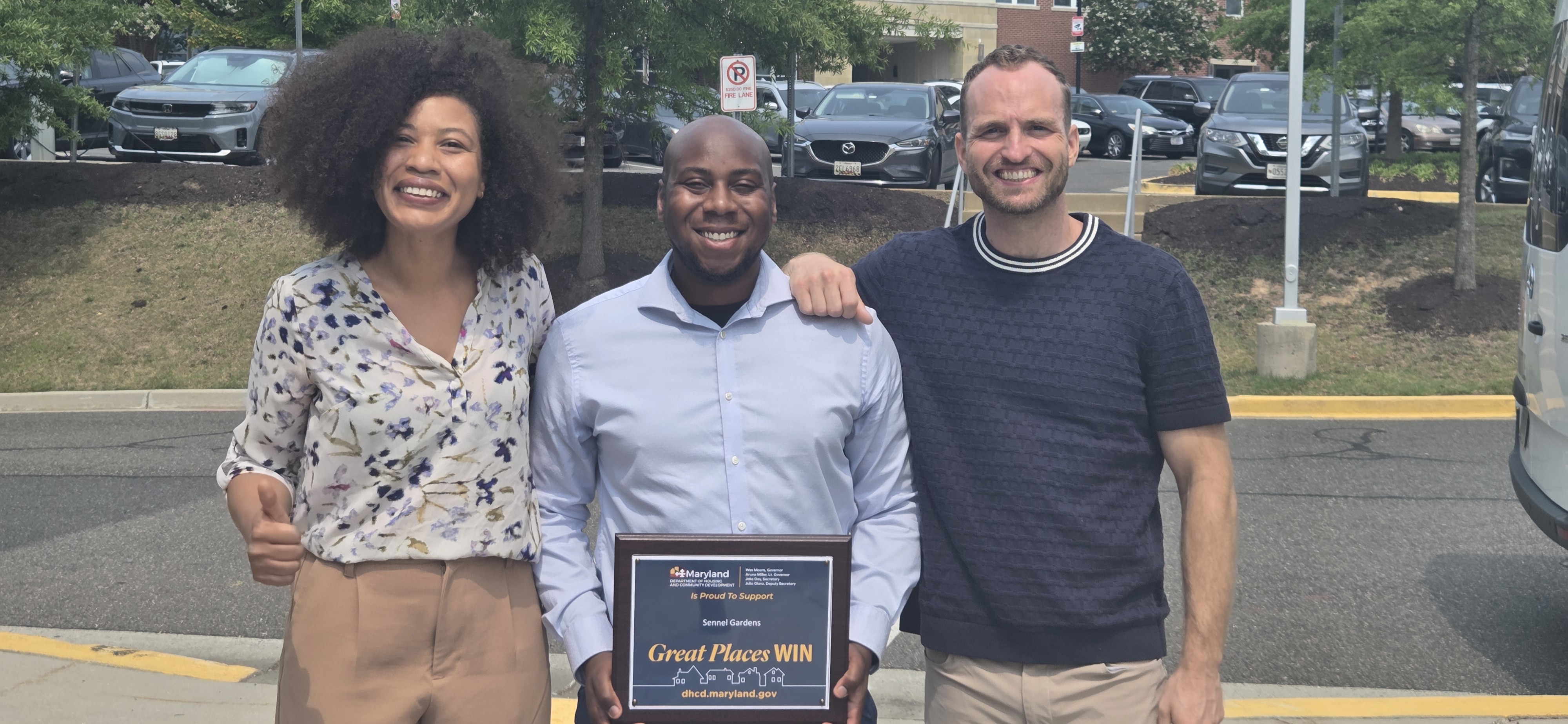 Manny McDaniel with Sennel Gardens team members holding the NourishMD grant plaque